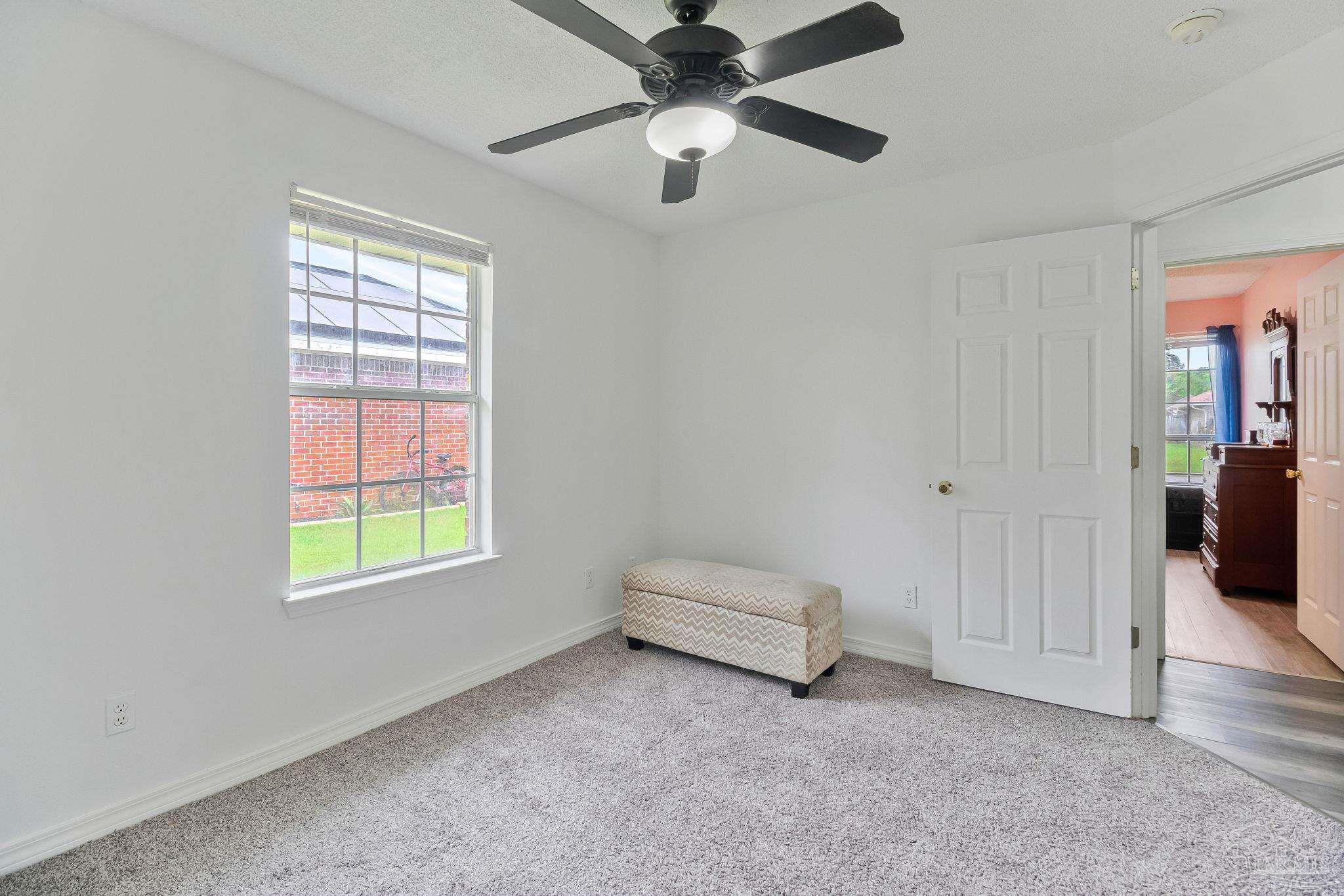 5691 Berrybrook Circle Pace, FL 32571 - Photo 15 of 22 an empty room with windows and ceiling fan