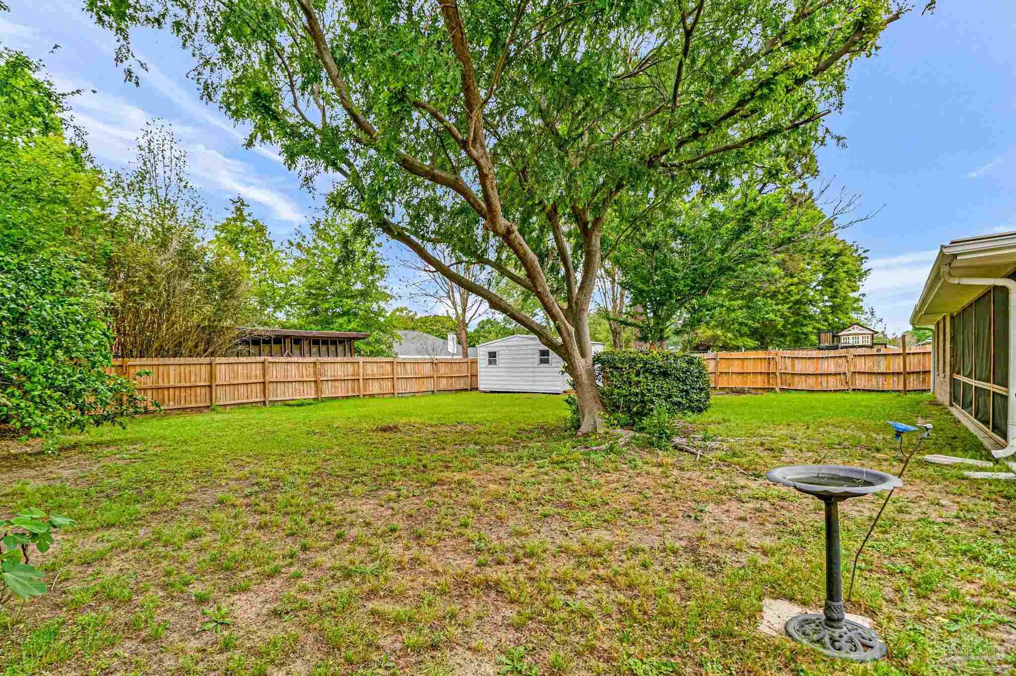 5691 Berrybrook Circle Pace, FL 32571 - Photo 18 of 22 a view of a backyard with a fountain