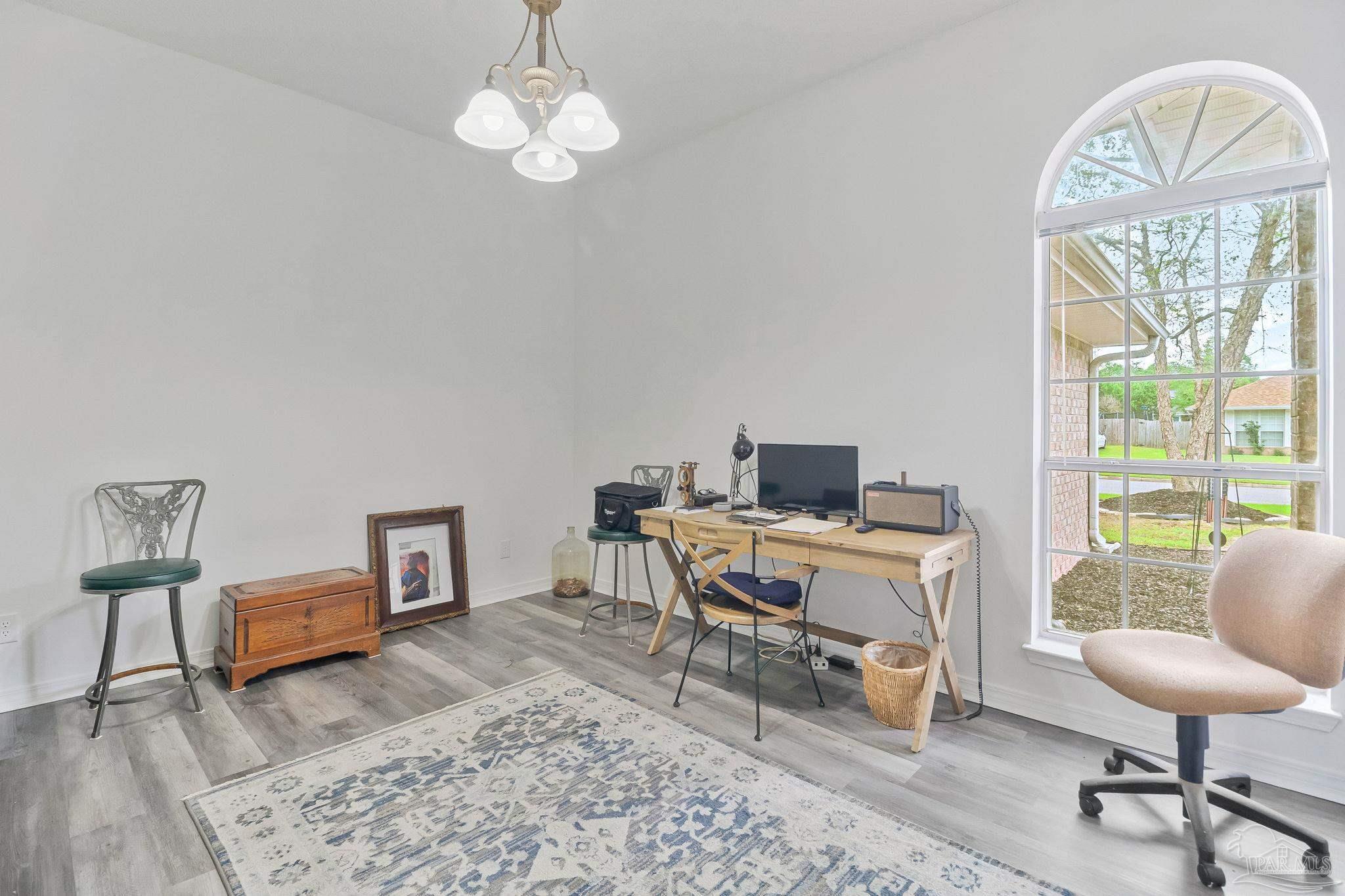 5691 Berrybrook Circle Pace, FL 32571 - Photo 4 of 22 a workspace with furniture window and wooden floor