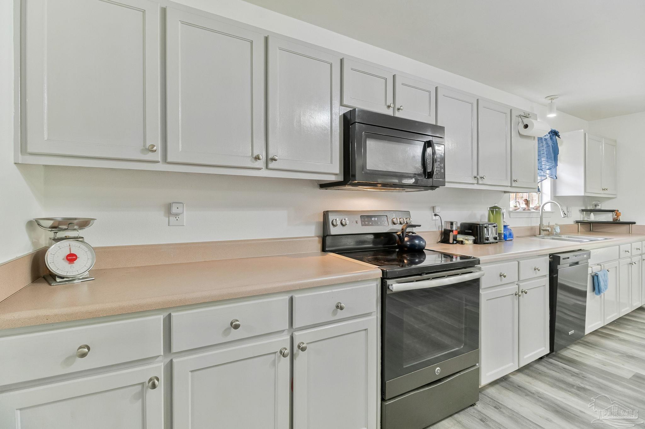 5691 Berrybrook Circle Pace, FL 32571 - Photo 5 of 22 a kitchen with cabinets appliances and a sink