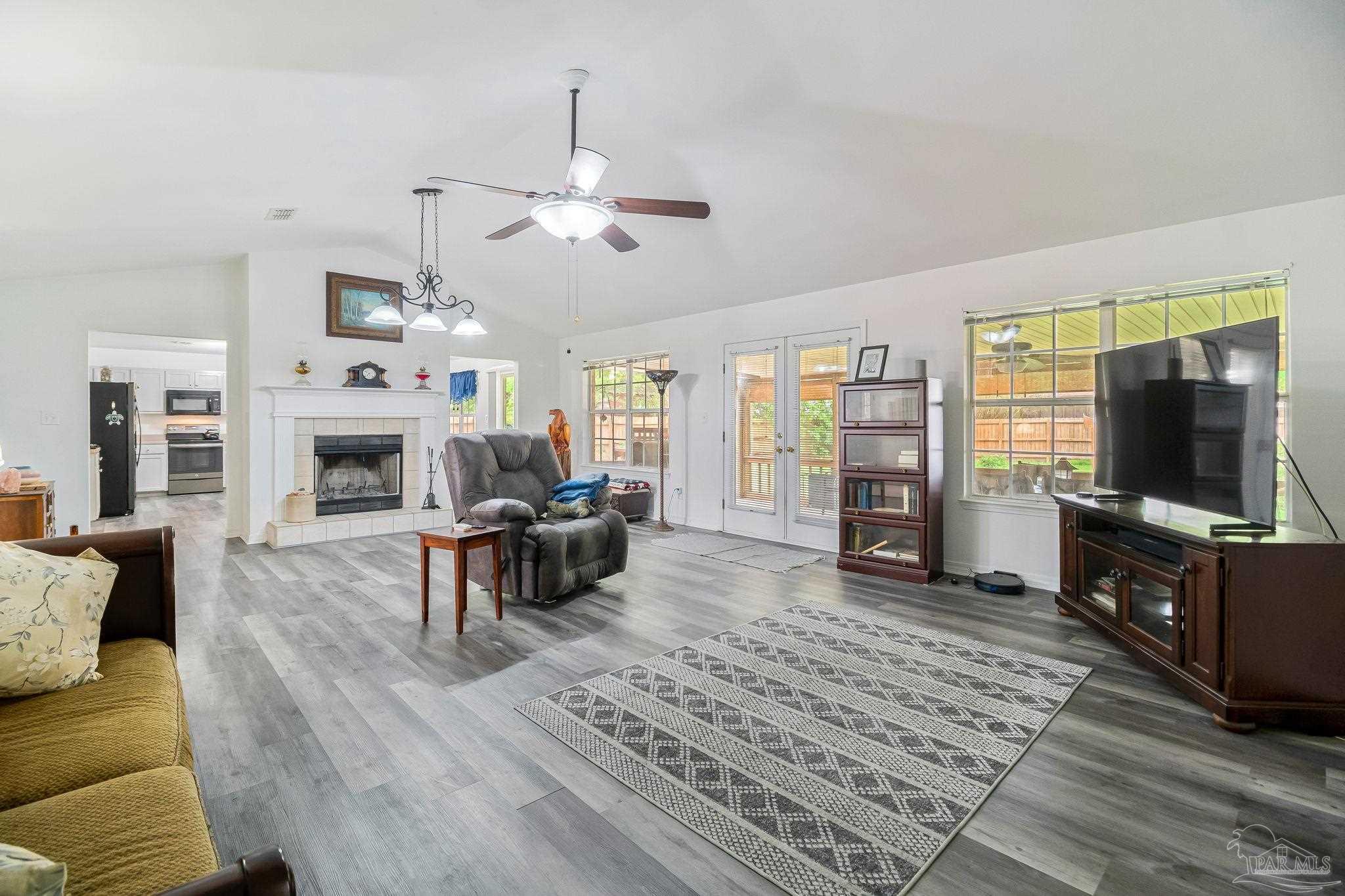 5691 Berrybrook Circle Pace, FL 32571 - Photo 9 of 22 a living room with furniture a flat screen tv and a fireplace