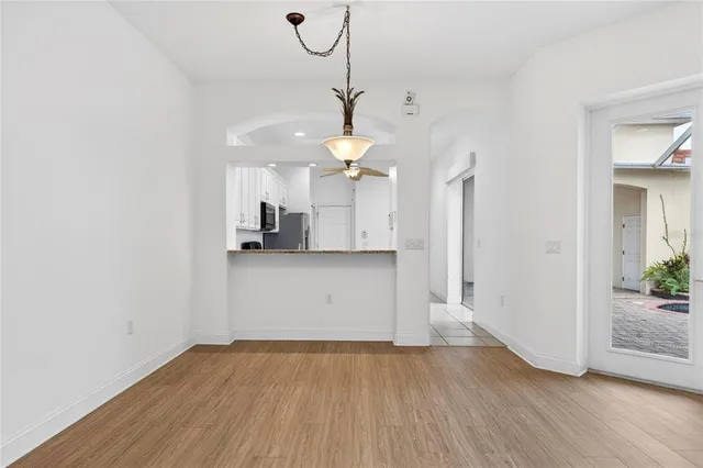 a view of a kitchen with a sink and dishwasher with wooden floor