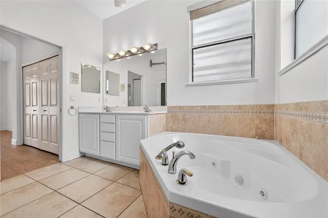 an empty room with a window and a ceiling fan