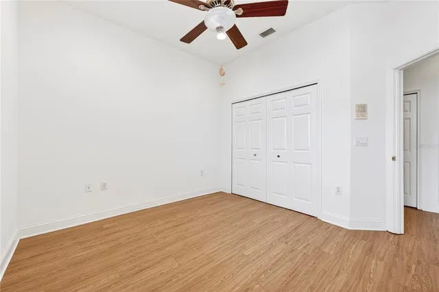 a bathroom with a granite countertop bathtub shower sink vanity and toilet