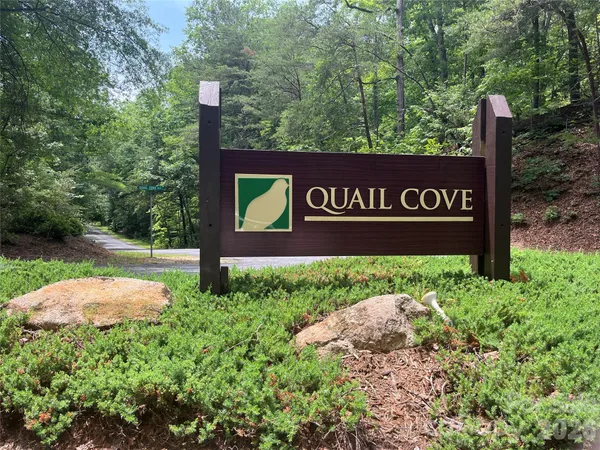 a view of outdoor space with sign board and yard