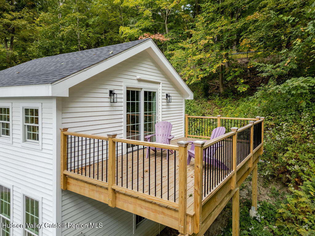 25 Catamount Road Hillsdale, NY 12529 - Photo 25 of 26 a view of a white house with a small deck and wooden fence