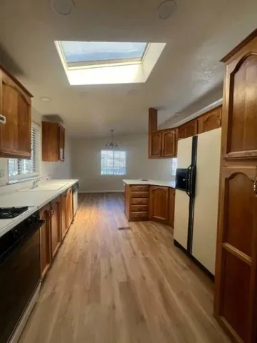 a kitchen with stainless steel appliances a refrigerator and a stove