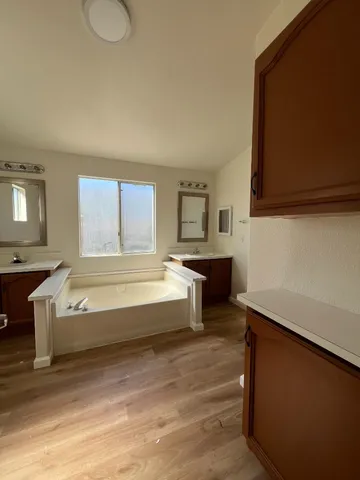 a spacious bedroom with a bed and window