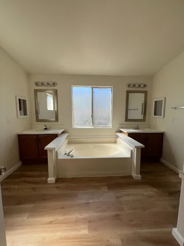 a spacious bedroom with a bed and window