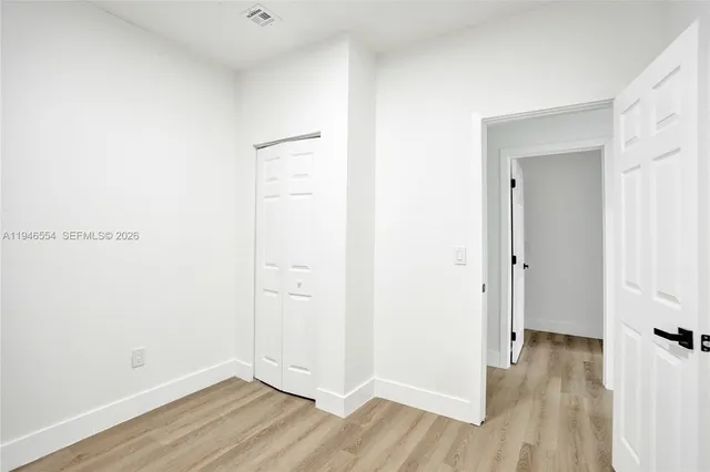 a view of a room with wooden floor
