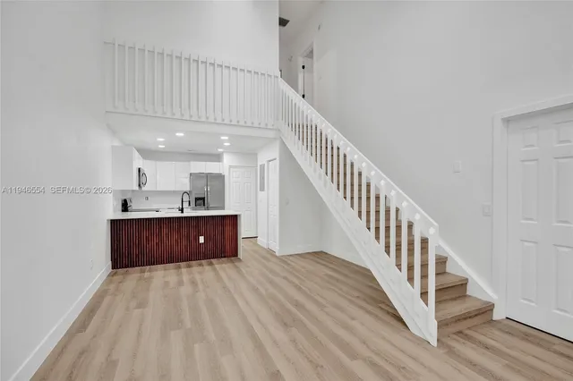 a room with wooden floors and stairs