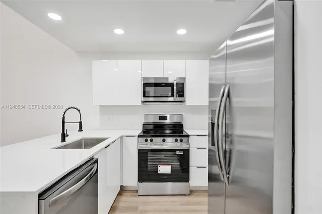 a kitchen with a sink a stove and refrigerator