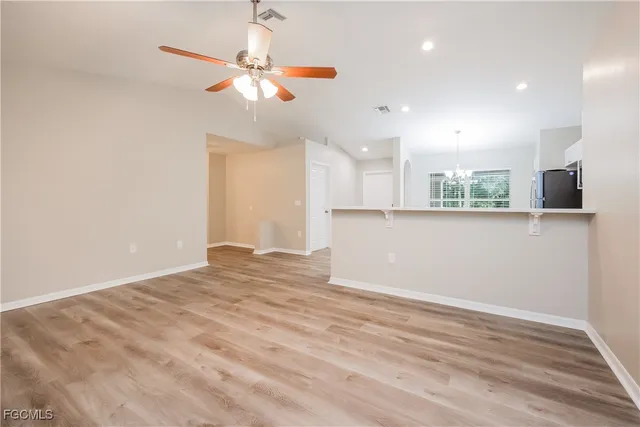 a view of a kitchen with a microwave and a ceiling fan