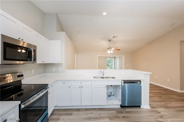 a kitchen with a sink stainless steel appliances and cabinets