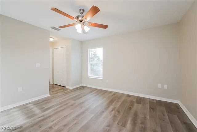 wooden floor in an empty room with a window