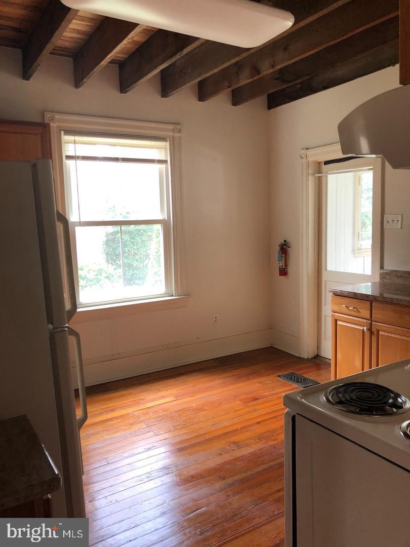 58 Darby Road, Unit 1 Paoli, PA 19301 - Photo 16 of 16 a view of an empty room with wooden floor and a window