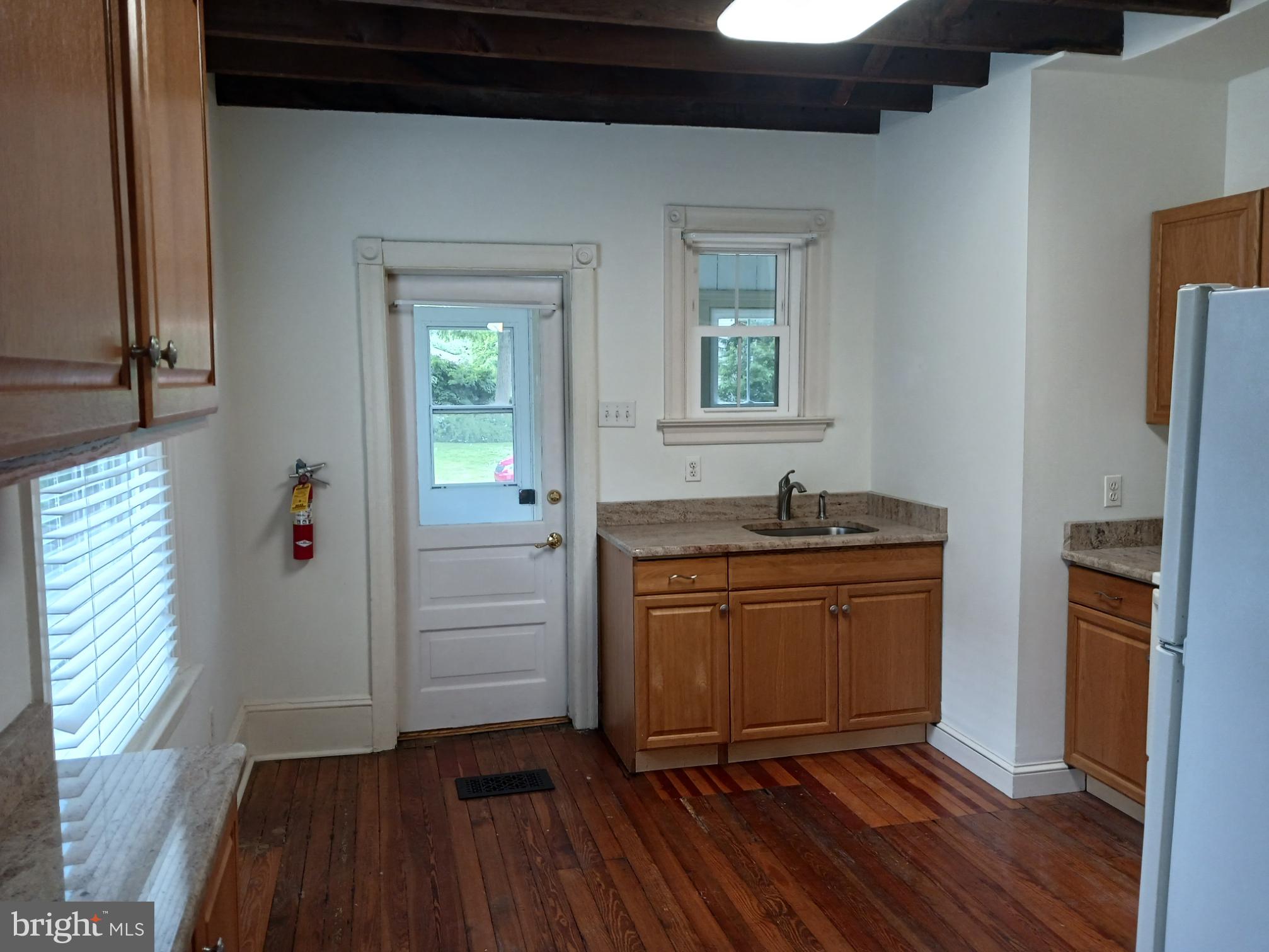 58 Darby Road, Unit 1 Paoli, PA 19301 - Photo 3 of 16 a room with granite countertop cabinets and wooden floor