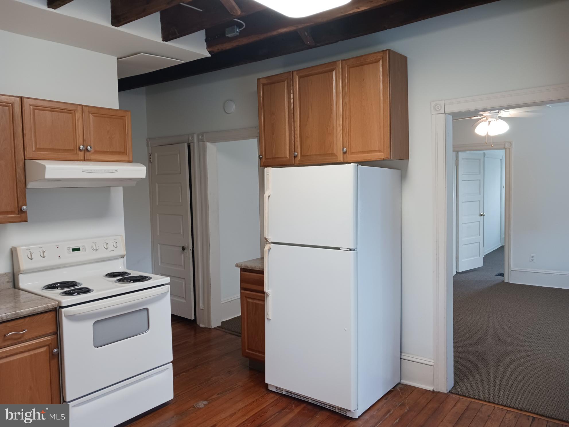 58 Darby Road, Unit 1 Paoli, PA 19301 - Photo 4 of 16 a white refrigerator freezer and a stove sitting inside of a kitchen