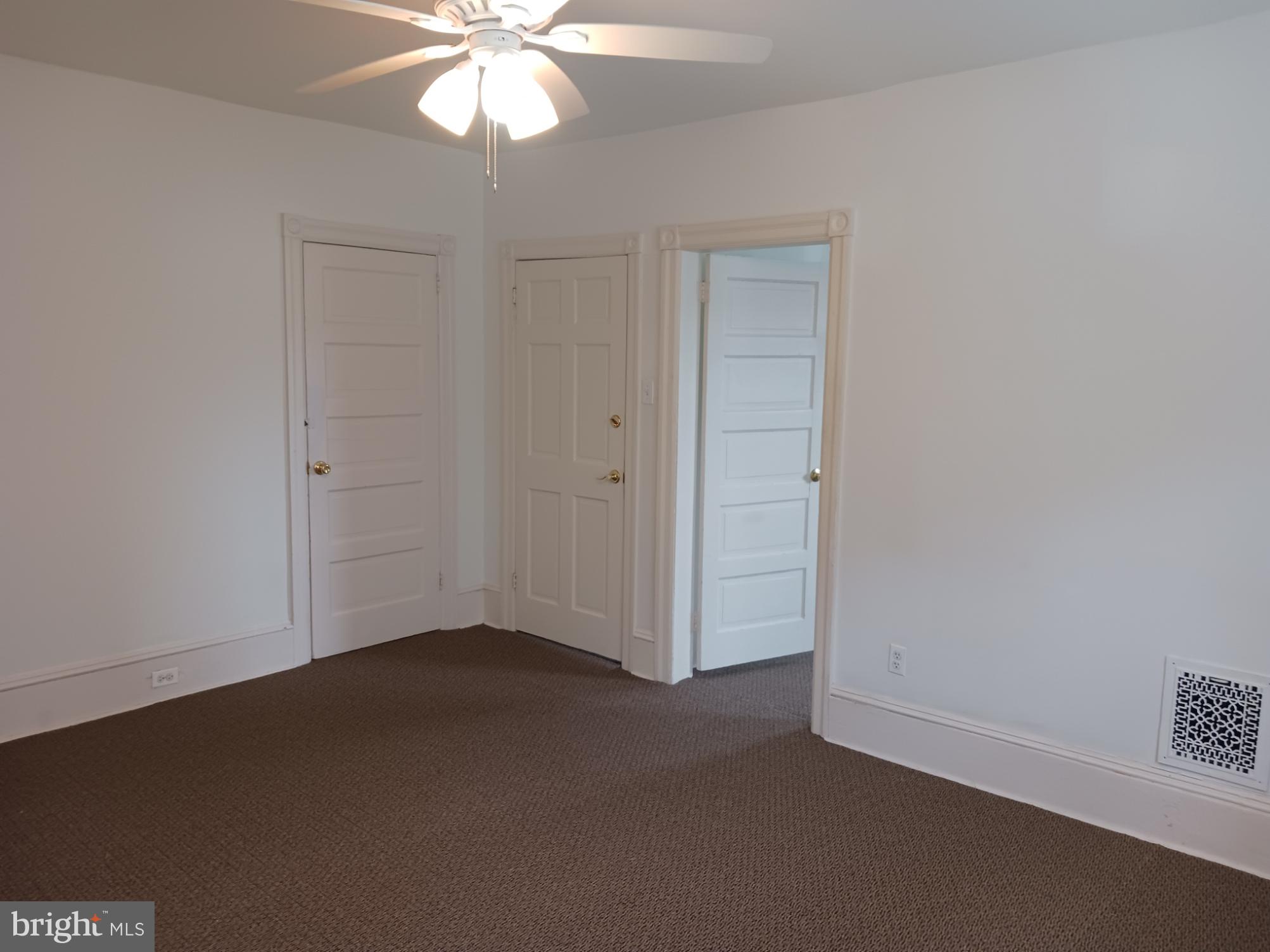 58 Darby Road, Unit 1 Paoli, PA 19301 - Photo 6 of 16 an empty room with a chandelier fan and closet