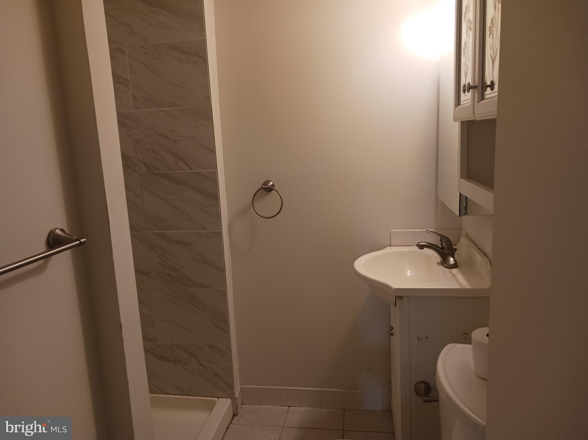 58 Darby Road, Unit 1 Paoli, PA 19301 - Photo 8 of 16 a bathroom with a sink and mirror