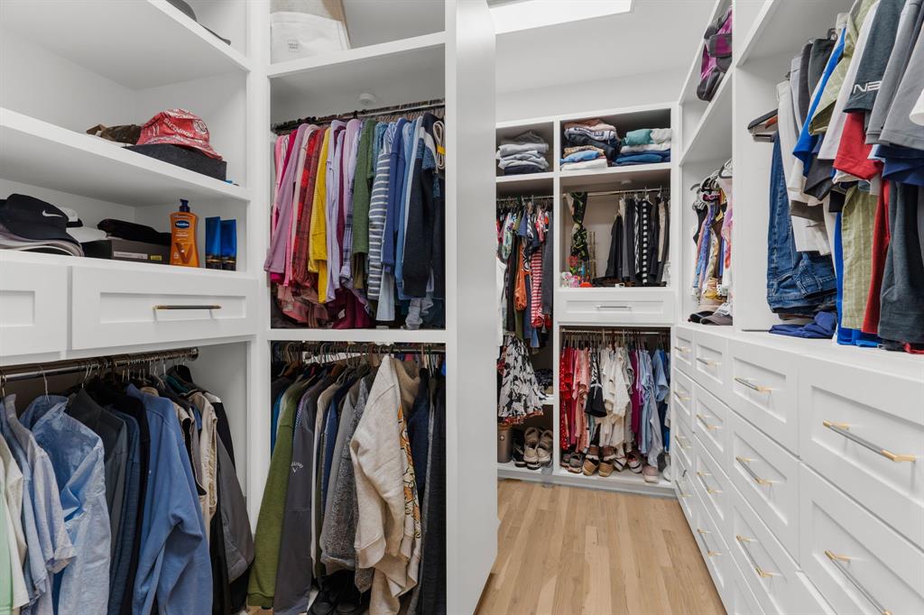 1307 Silverlake Road McKinney, TX 75072 - Photo 18 of 33 a view of walk in closet with clothes and shoes