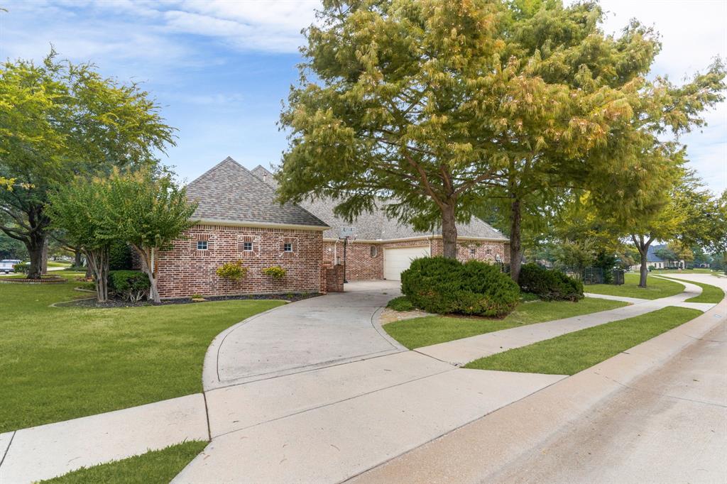 1307 Silverlake Road McKinney, TX 75072 - Photo 32 of 33 a front view of a house with a yard garage and outdoor seating