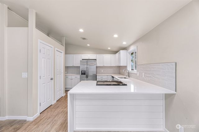 a kitchen with stainless steel appliances a refrigerator and a sink