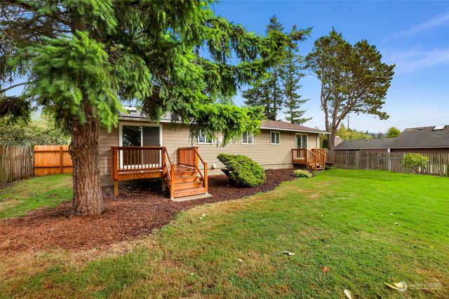 a view of a yard with wooden fence