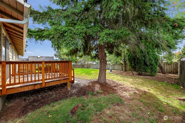 a view of a house with backyard sitting area and garden
