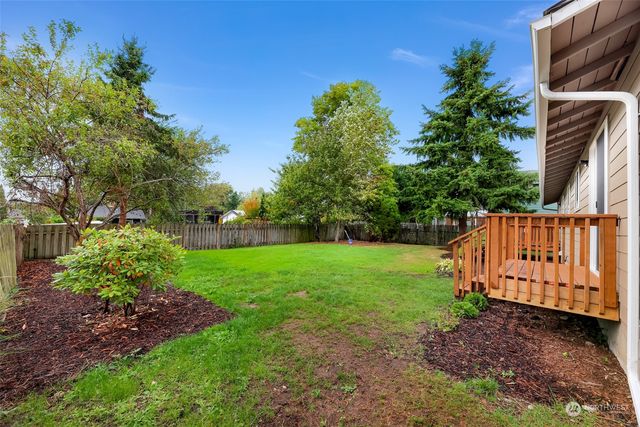 a view of a house with a yard and sitting area