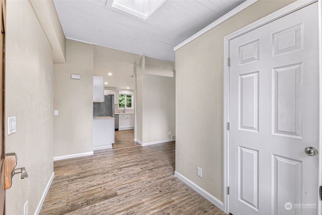 a view of empty room with wooden floor