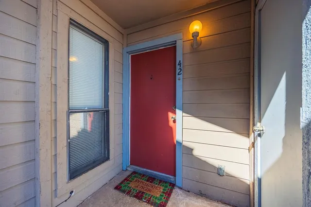 a kitchen with granite countertop a sink and dishwasher a stove top oven with wooden floor