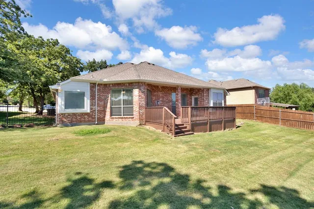 a view of a house with a yard and sitting area