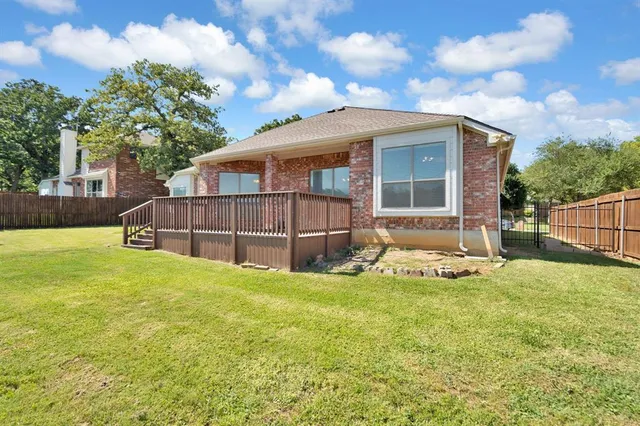 a view of a house with a yard and sitting area