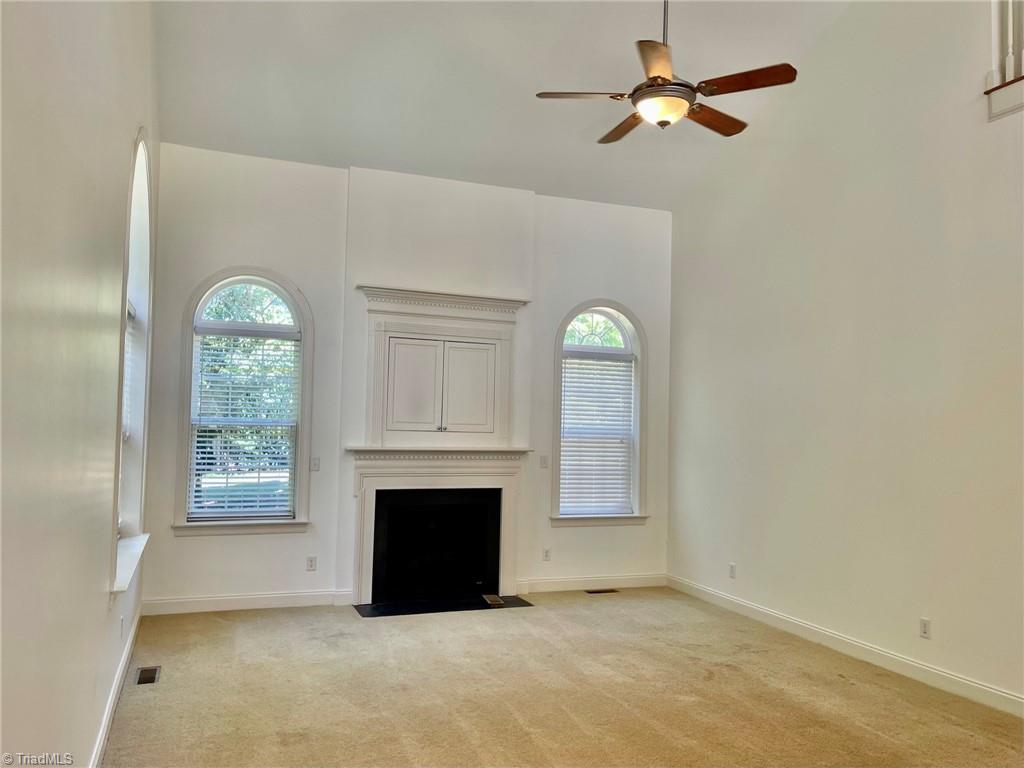 7798 Elizabeth Drive Oak Ridge, NC 27310 - Photo 7 of 26 Two story den with fireplace