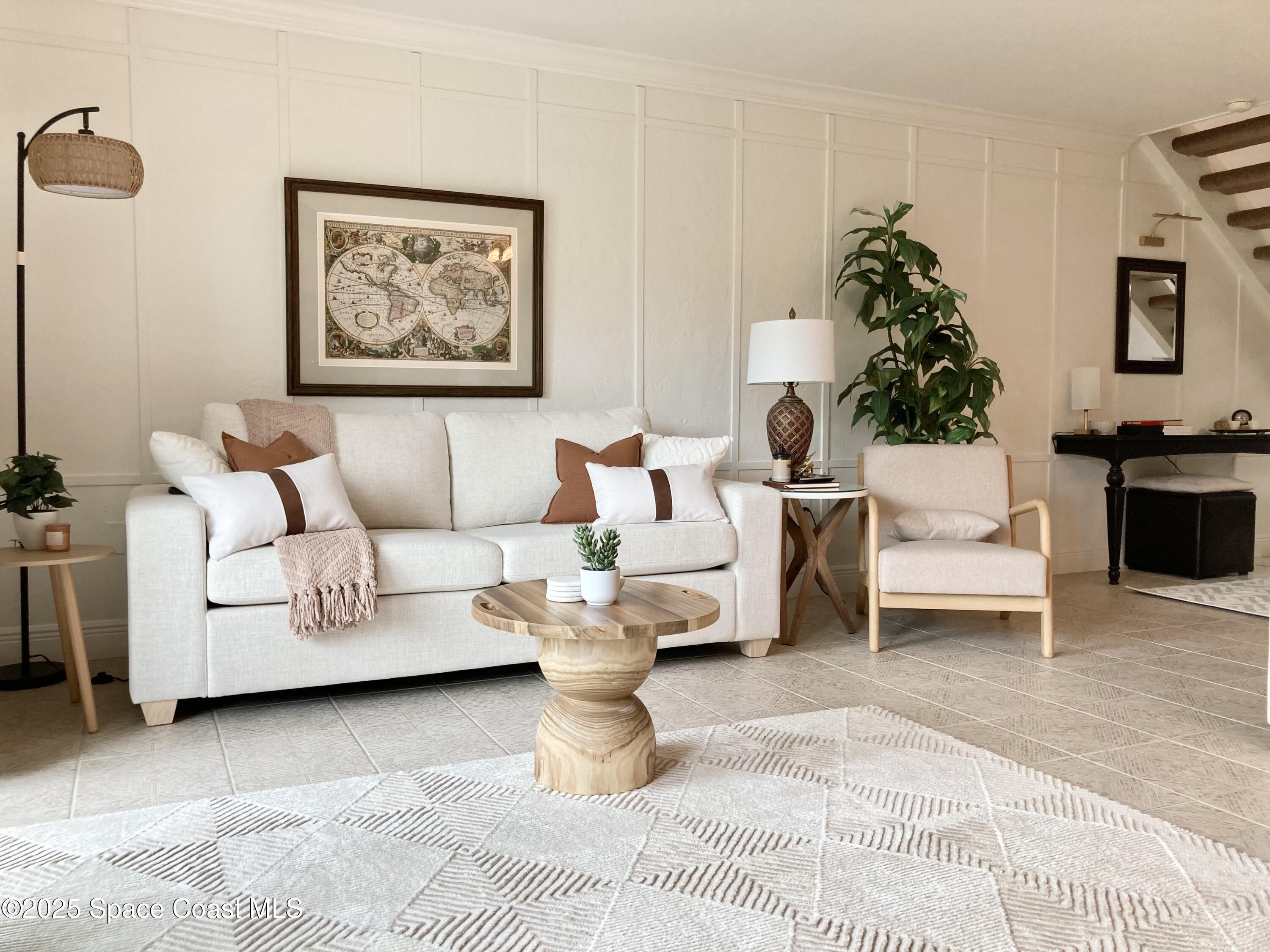 7 Cove Road Melbourne Beach, FL 32951 - Photo 14 of 55 a living room with furniture and a potted plant on a dresser