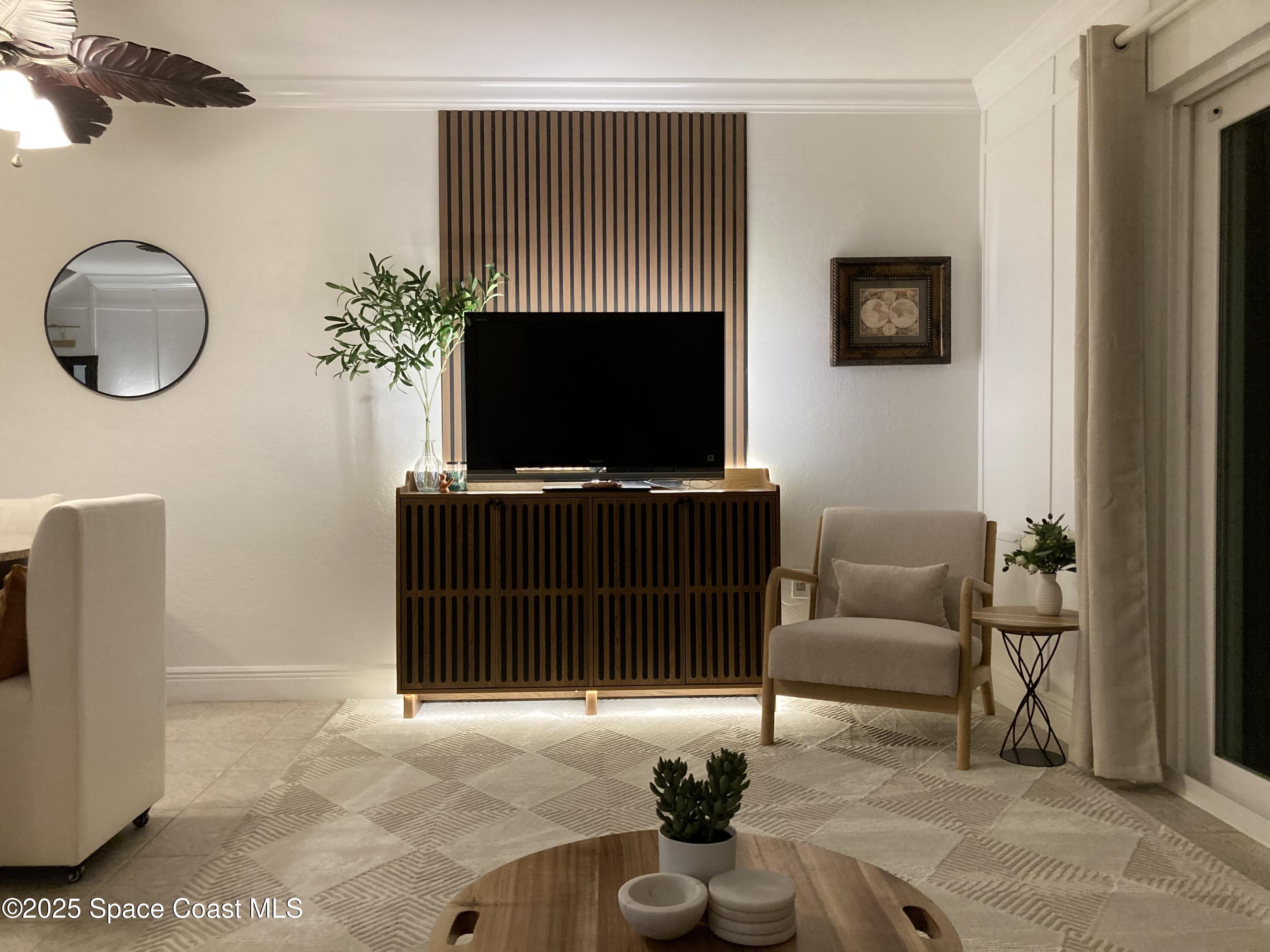 7 Cove Road Melbourne Beach, FL 32951 - Photo 16 of 55 a living room with furniture a flat screen tv and a potted plant