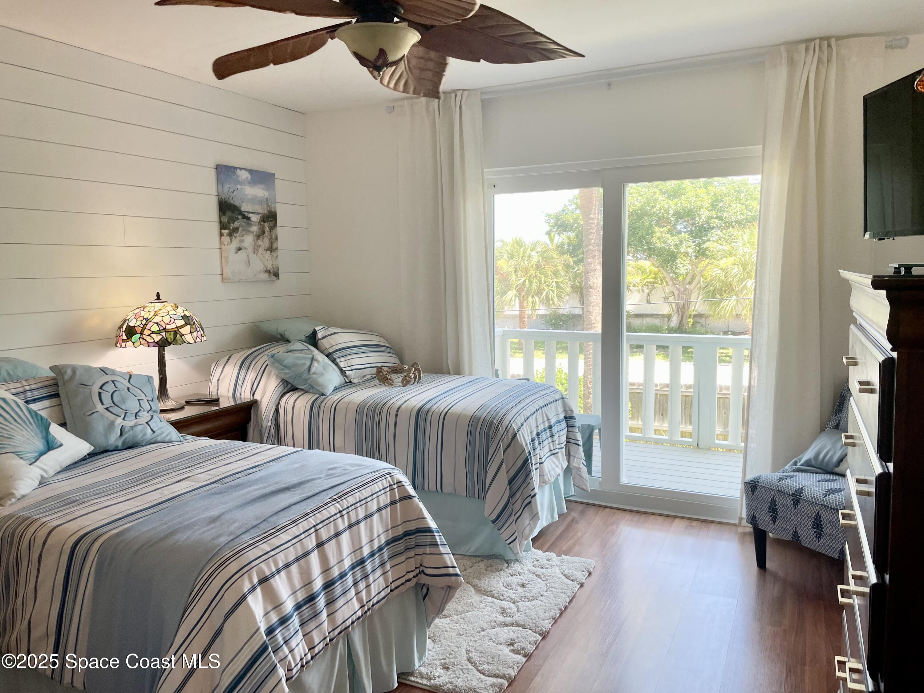 7 Cove Road Melbourne Beach, FL 32951 - Photo 20 of 55 a bedroom with two beds and a flat screen tv