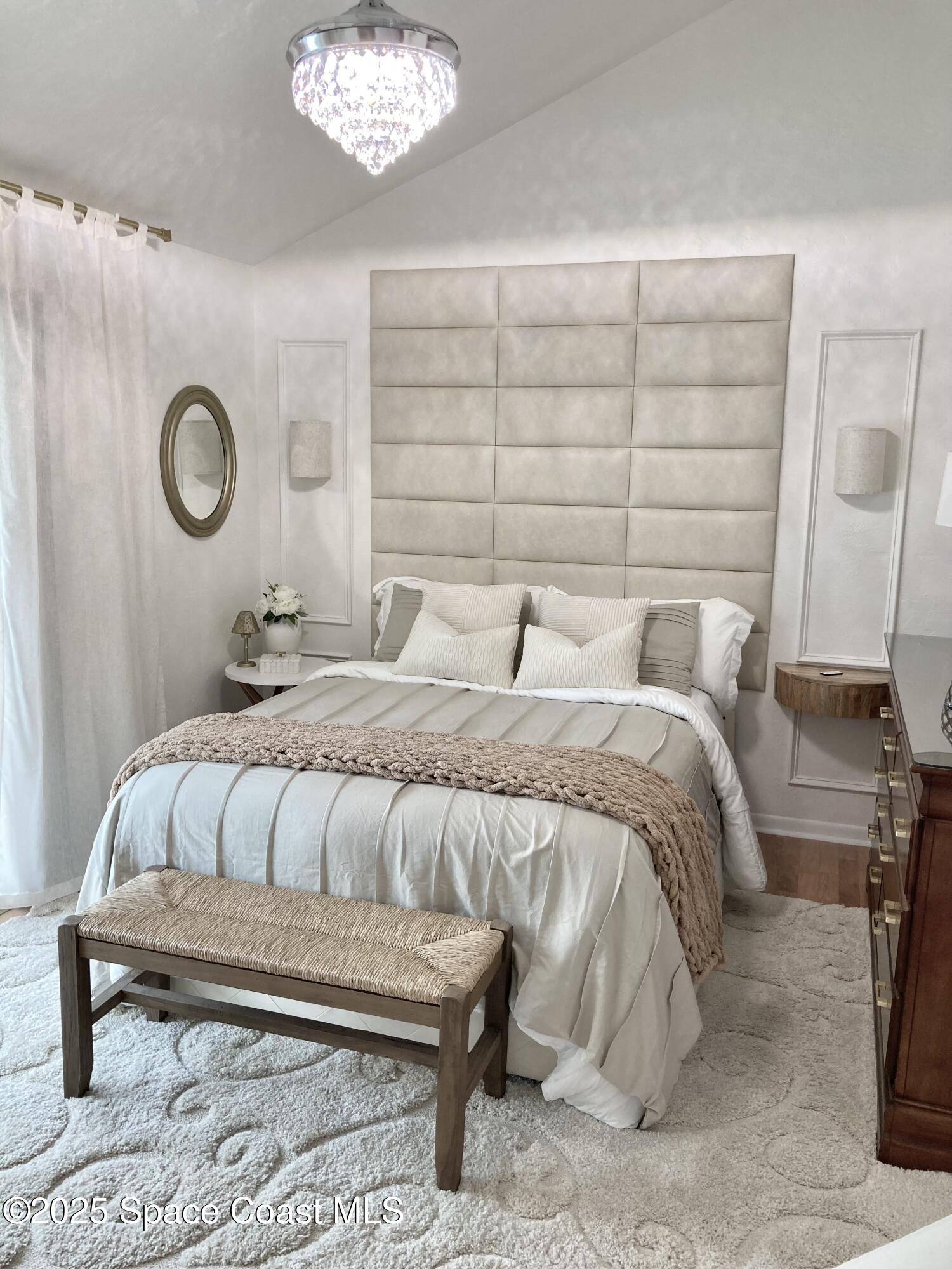 7 Cove Road Melbourne Beach, FL 32951 - Photo 24 of 55 a bedroom with a bed and a chandelier