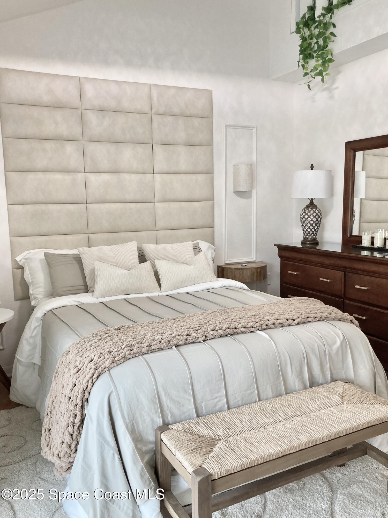 7 Cove Road Melbourne Beach, FL 32951 - Photo 25 of 55 a bedroom with a bed and a potted plant