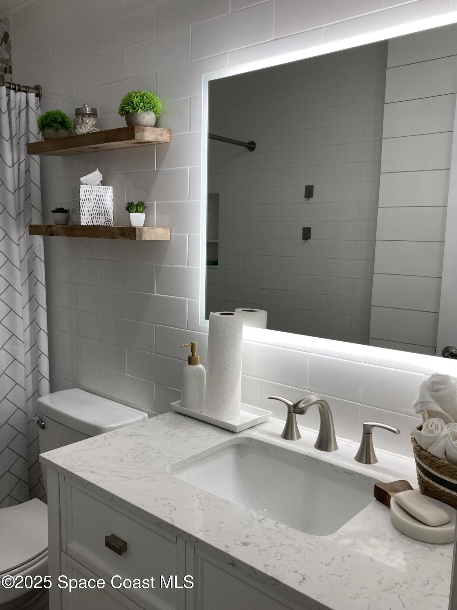 7 Cove Road Melbourne Beach, FL 32951 - Photo 26 of 55 a bathroom with a bathtub and sink