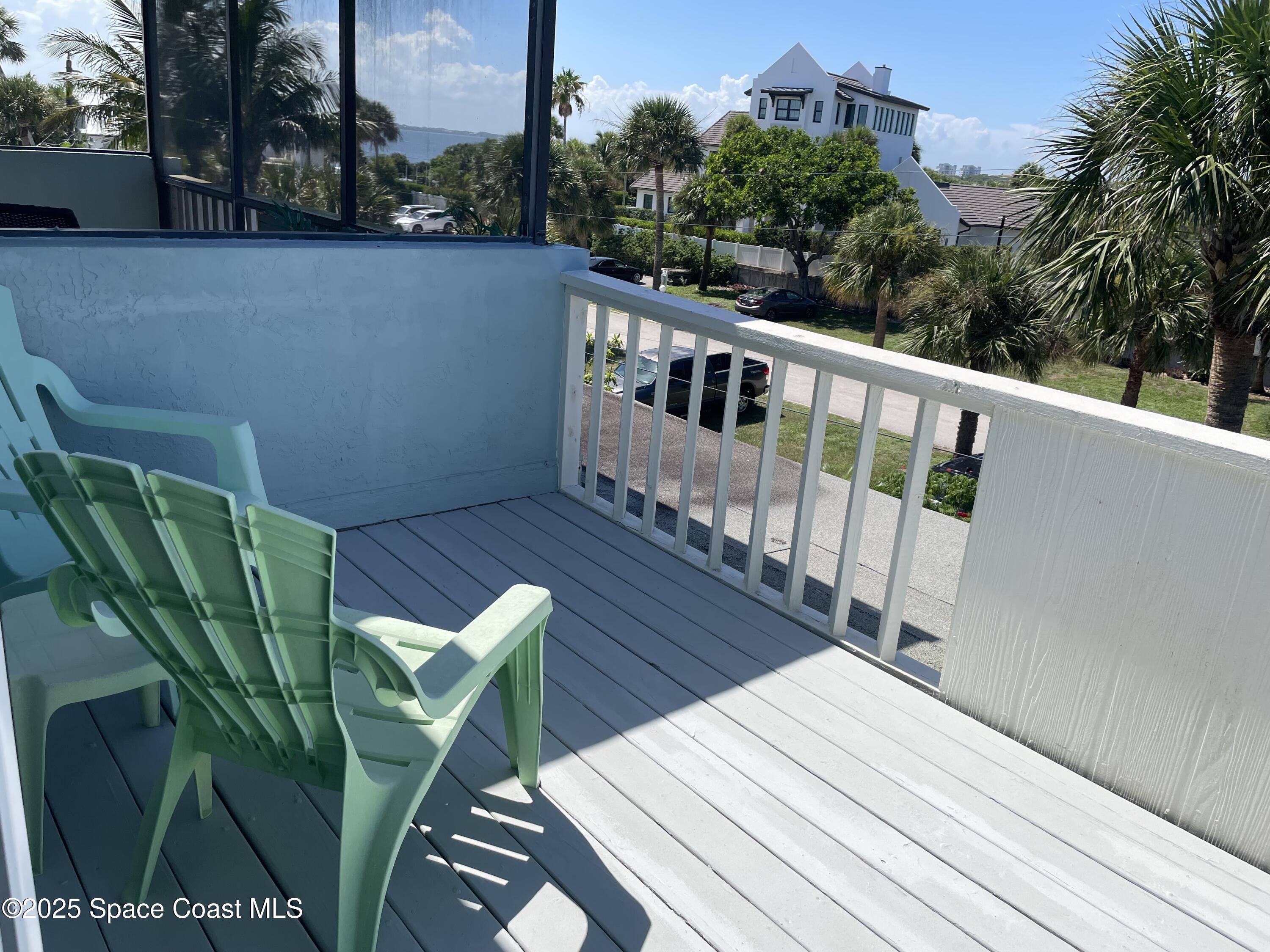 7 Cove Road Melbourne Beach, FL 32951 - Photo 38 of 55 a view of balcony with wooden floor and outdoor seating