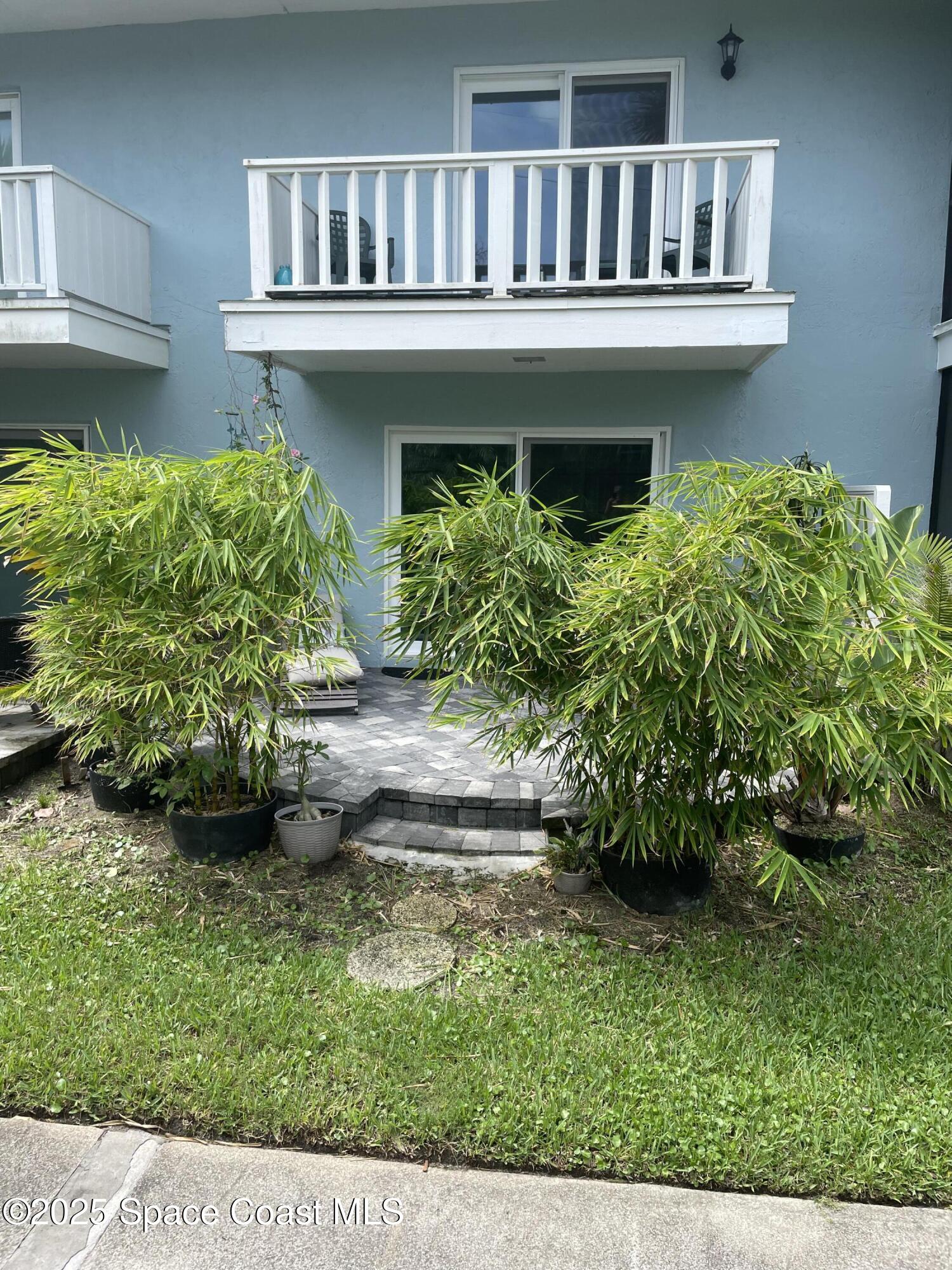 7 Cove Road Melbourne Beach, FL 32951 - Photo 41 of 55 a view of a house with a yard and potted plants