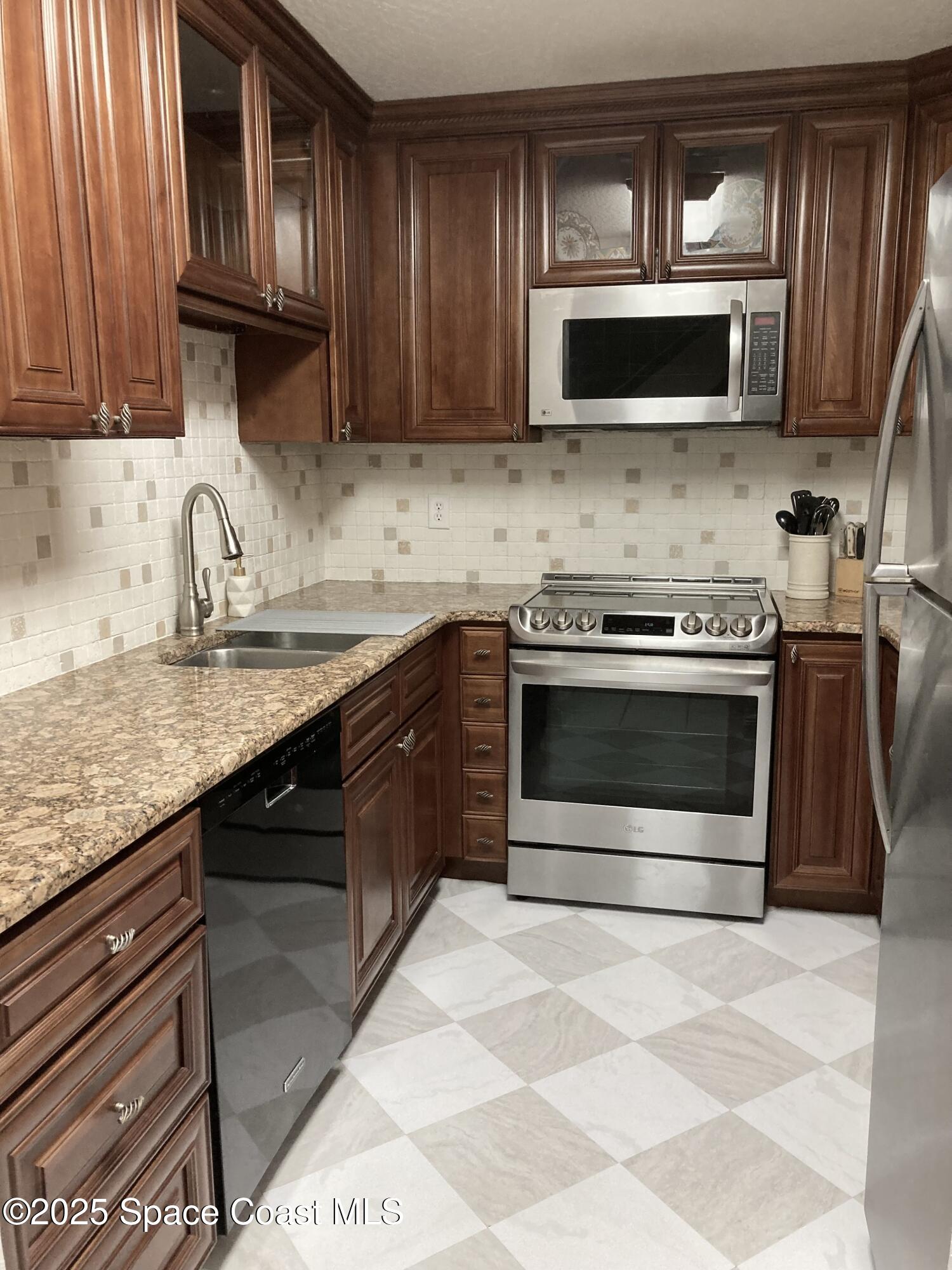7 Cove Road Melbourne Beach, FL 32951 - Photo 9 of 55 a kitchen with a stove and a microwave