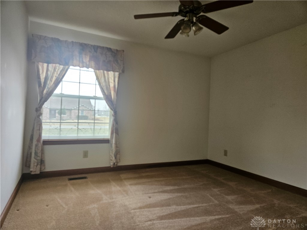 4909 Shannon Avenue Springfield, OH 45504 - Photo 9 of 21 Bright and airy, this comfortable room offers carpeted flooring and a window with natural light.