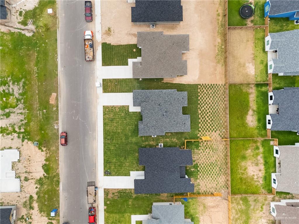 18054 Spruce Street Combes, TX 78552 - Photo 24 of 25 Newly constructed residences featuring dark shingle roofing, concrete driveways, and established lawns
