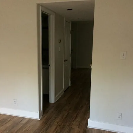 a view of a hallway with wooden floor