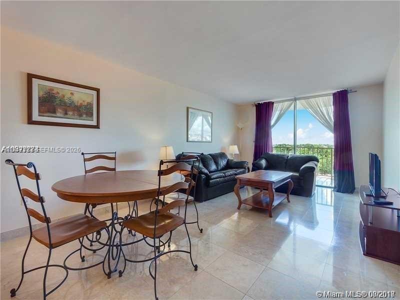 210 Seaview Drive, Unit 607 Key Biscayne, FL 33149 - Photo 2 of 4 a living room with furniture and a window
