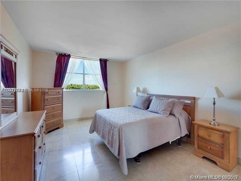210 Seaview Drive, Unit 607 Key Biscayne, FL 33149 - Photo 3 of 4 a bedroom with a bed and a window