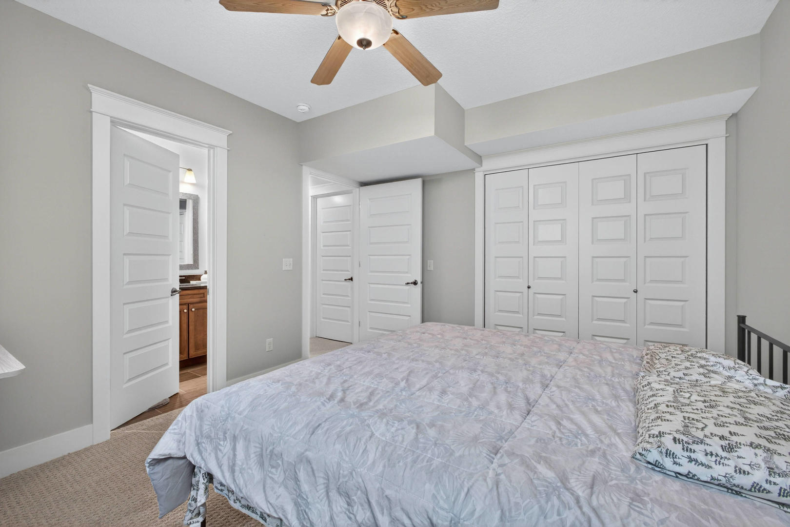 5700 Emily Road Bettendorf, IA 52722 - Photo 45 of 58 a bedroom with a large bed and a chandelier